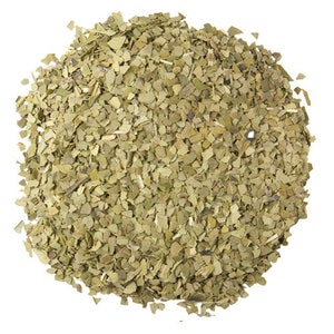 May include: A close-up of a pile of dried green yerba mate leaves, a popular South American herbal tea.