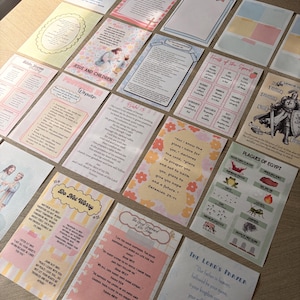 May include: A collection of rectangular paper cards featuring religious themes, scripture verses, and illustrations. The cards display various designs including floral patterns, depictions of figures, and lists of biblical concepts in black text.