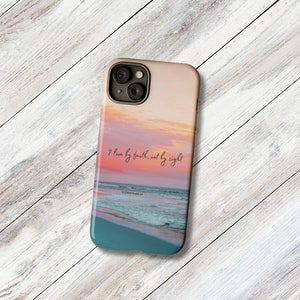 a phone case with a picture of the ocean and a sunset