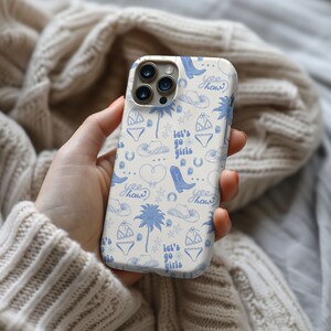 a person holding a cell phone in their hand