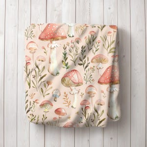 a pink bag with mushrooms and leaves on it