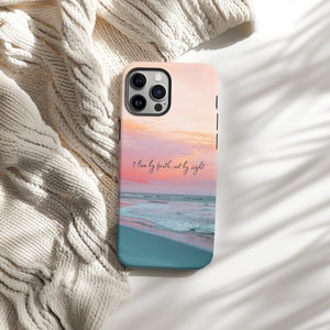 a phone case sitting on top of a bed next to a blanket
