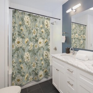 a bathroom with a floral shower curtain next to a toilet
