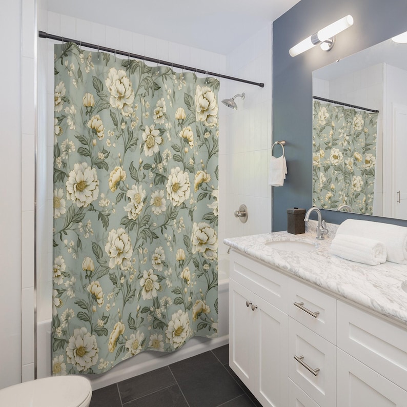 a bathroom with a floral shower curtain next to a toilet