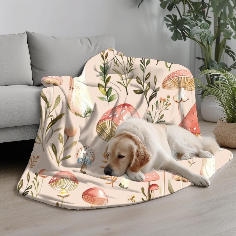 a dog laying on a couch covered in a blanket