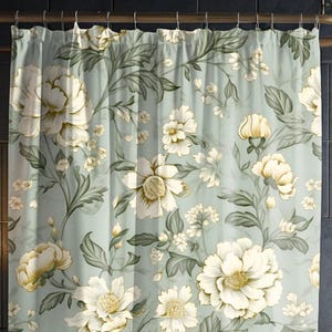 a shower curtain with a flower pattern on it
