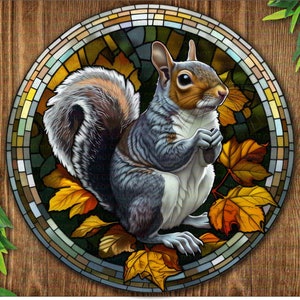 May include: A stained glass style illustration of a gray squirrel sitting on a bed of autumn leaves. The squirrel is looking to the right and has a bushy tail.