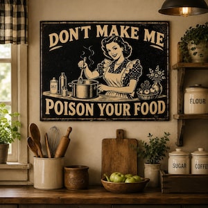 May include: A rectangular metal sign with a black background and cream-colored text reading DON'T MAKE ME POISON YOUR FOOD. The illustration features a woman in a polka-dot dress and apron stirring a pot on a stove, surrounded by kitchen items.