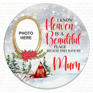 May include: A round, white, winter-themed memorial ornament with a gold frame for a photo. The text reads "I know Heaven is a Beautiful Place because they have my Mum".