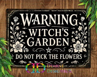 May include: Black metal sign with white text that reads "WARNING WITCH'S GARDEN DO NOT PICK THE FLOWERS." The sign has floral and star designs. The bottom of the sign has the text "DEARNE DESIGNSUK" in a rainbow color.