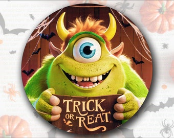May include: A green one-eyed monster with a toothy grin holds a sign that says "Trick or Treat". The monster is against a brown wooden background with bats and cobwebs.