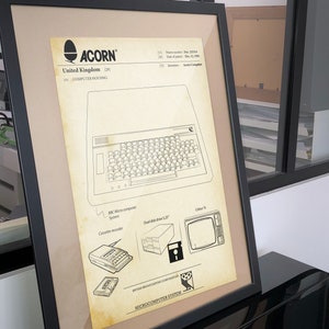 May include: A black and white line drawing of the Acorn BBC Microcomputer System. The drawing shows the computer housing, a cassette recorder, a dual disk drive, and a color TV. The text "BRITISH BROADCASTING CORPORATION" and "MICROCOMPUTER SYSTEM" are also included in the drawing.
