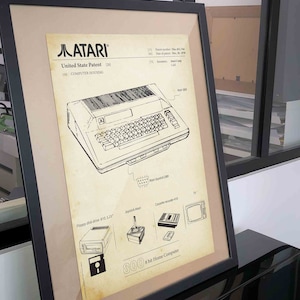 May include: A vintage-style illustration of the Atari 800 home computer, including a diagram of the computer's components, such as the floppy disk drive, joystick, and cassette recorder. The illustration is in black and white and has a yellowed background, giving it a retro look.