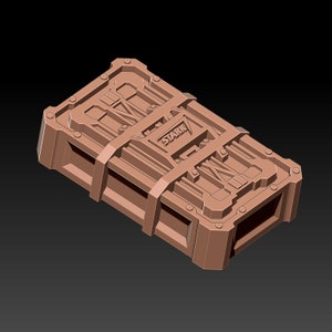 May include: A brown, rectangular box with a textured surface and the word "STARK" embossed on the top. The box has a series of straps and buckles.