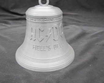 May include: A silver bell with the words "AC/DC" and "Hell's Bell" engraved on it.