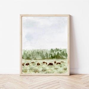 May include: Watercolor painting of a forest landscape with a herd of bison grazing in a field. The sky is a light blue with white clouds. The trees are a dark green and the grass is a light green.