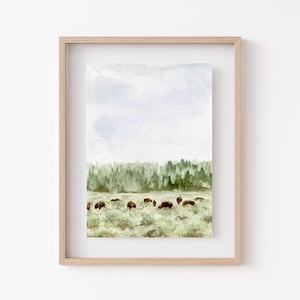 May include: Watercolor painting of a herd of bison grazing in a field with a forest in the background. The sky is a light blue with white clouds.