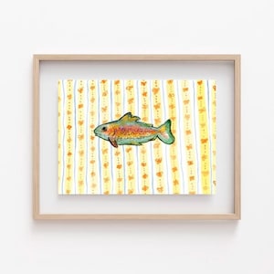 May include: A framed watercolor print featuring a colorful fish with orange, yellow, and green hues. The fish is set against a background of yellow and white vertical stripes adorned with orange butterfly motifs. The frame is a light wood color.