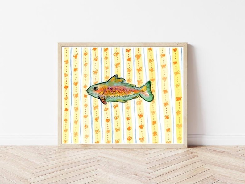 A high quality watercolor art print of a colorful fish. The fish is depicted with shades of green, yellow, orange, and blue. The background features vertical stripes with a pattern of orange hearts and blue lines. - no frame is included in purchase