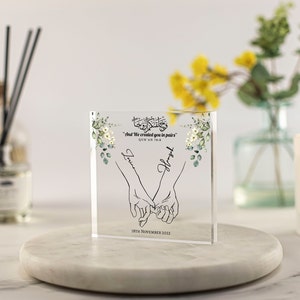 May include: A clear acrylic block with a floral design and the text "And We created you in pairs" Quran 78:8. The block also includes two names, "Love" and "Hope", and the date "18th November 2023".