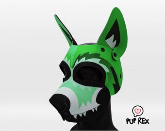 May include: A green and black dog-themed mask with white accents. The mask features large, upright ears, a snout, and a detailed design. The mask is designed to be worn and has a playful aesthetic. The Pup Rex logo is visible.