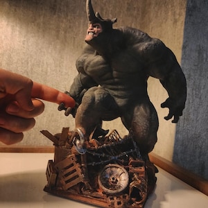May include: A green and grey rhinoceros figurine standing on a pile of scrap metal. The figurine is detailed with textured skin and a menacing expression.