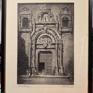 May include: Black and white framed print of an ornate architectural doorway. The print features detailed carvings, arched entrance, and figures. The words "Ancient Doorway" are printed at the bottom, along with the artist's signature. The frame is black with a gold inner edge.