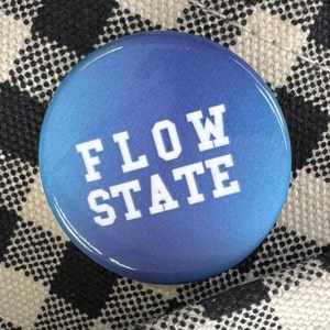 May include: A blue button with a white gradient and the text "FLOW STATE" in white.
