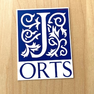 May include: A blue and white sticker with a decorative white letter J and the word "ORTS" in white letters.