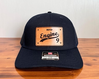 May include: Black trucker hat with a brown leather patch that says "HFD Engine 9".