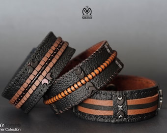 May include: Three leather bracelets with brown and black leather straps and metal accents. The bracelets are stacked on top of each other. The text "Men's Bracelets Leather Collection" is visible at the bottom of the image.