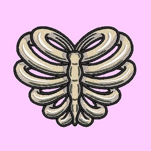 May include: A heart-shaped ribcage design with a white and gray color scheme. The ribcage is outlined in black and has a detailed, embroidered look.