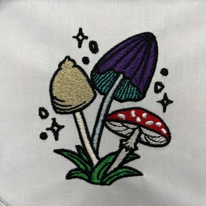 Magical mushroom cluster embroidery file in a fantasy fairy garden. Cute mushrooms from a magical garden. Completed stitch sample to so quality and details.