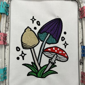 Magical mushroom cluster embroidery file in a fantasy fairy garden. Cute mushrooms from a magical garden. Completed stitch sample to so quality and details.