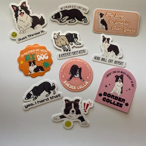 May include: A set of ten colorful stickers featuring border collies with various phrases and designs. The stickers include phrases like "My Dog Is Smarter Than Yours", "I'd Rather Be With My Dog", and "Herd Ball. Eat. Repeat."