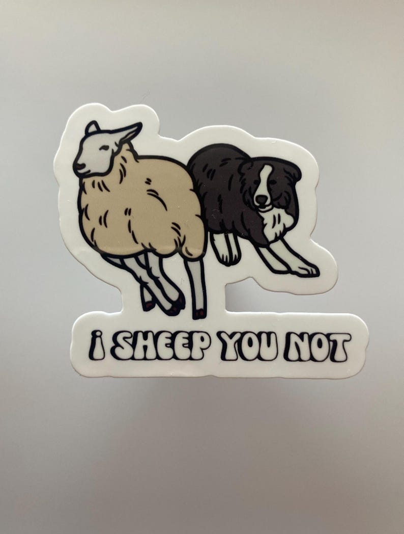 May include: A white sticker with a black and white illustration of a sheep and a dog. The text "i sheep you not" is written in black below the illustration.