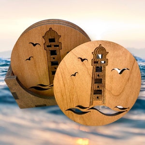 May include: Set of four wooden coasters featuring a lighthouse design. Each coaster is round and has a brown wood finish. The lighthouse is cut out of the wood and is surrounded by waves. There are also small birds cut out of the wood.