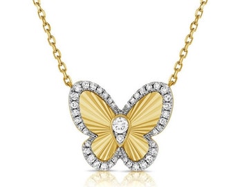 May include: A gold butterfly necklace with a diamond accent. The butterfly is detailed with a textured pattern and surrounded by a halo of smaller diamonds.
