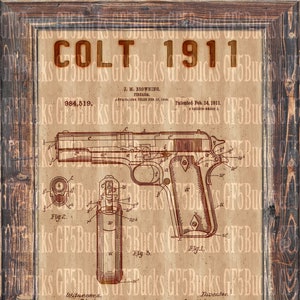 May include: A framed print featuring a vintage Colt 1911 firearm patent diagram. The diagram is in brown ink on a tan background, with detailed schematics and text. The frame is made of dark wood.