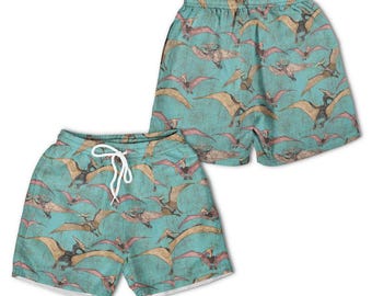 Pantalones cortos hawaianos para jóvenes con estampado de dinosaurio Pteranodon en vuelo en verde azulado