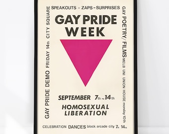 May include: A framed poster with a cream background featuring a large magenta downward-pointing triangle. The text reads GAY PRIDE WEEK, SPEAKOUTS-ZAPS-SURPRISES, SEPTEMBER 7th-14th, HOMOSEXUAL LIBERATION, GAY PRIDE DEMO, and GAY POETRY/FILMS.