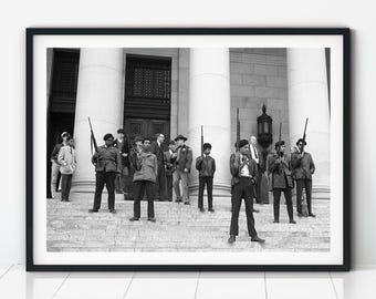 May include: Black and white framed photograph of a group of people, some holding rifles, standing on the steps of a building with large columns. The image is a historical depiction of a political event.