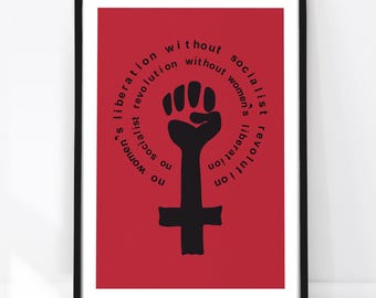 May include: A framed poster with a red background featuring a black graphic of a raised fist combined with a female gender symbol. The text 'no socialist revolution without women's liberation no women's liberation without socialist revolution' is printed.