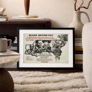 May include: A framed poster with the text "BLACK NATION DAY" and "Celebrate the 15th anniversary of the Provisional Government of the Republic of New Afrika." The poster includes images of people and text about an event at Wayne State University.
