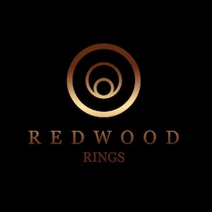 May include: A logo for Redwood Rings, featuring a stylised image of three concentric circles in gold on a black background.