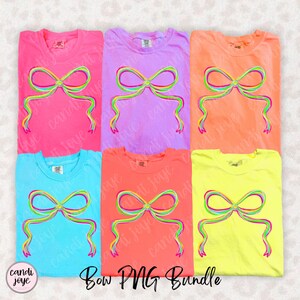 May include: Six colorful t-shirts in pink, purple, orange, blue, coral, and yellow, each featuring a vibrant bow design with rainbow-colored outlines. The text "Bow PNG Bundle" is at the bottom. The brand name "candi joye" is in the bottom left corner.