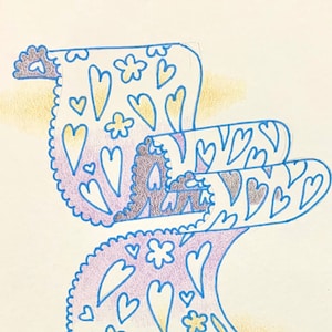 May include: A hand-drawn illustration of a purple and yellow patterned design with hearts and flowers. The design is drawn in blue and purple pencil on white paper.