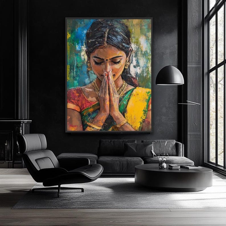 Indian wall art May include: An oil painting depicts a woman in traditional Indian attire with hands clasped in prayer. The artwork features vibrant colors, including red, yellow, and green, set against a backdrop of blue and teal. Gold jewelry adorns the woman.