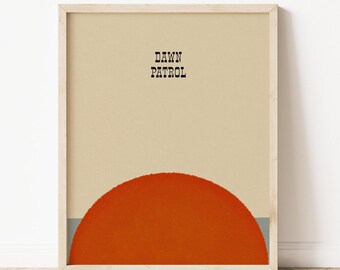 Può includere: Un poster minimalista con il testo "DAWN PATROL" in lettere nere su uno sfondo beige. Un grande semicerchio arancione si trova nella parte inferiore del poster.