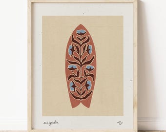 May include: A framed print of a stylized surfboard with a floral design. The surfboard is red with blue flowers and brown stems. The print is on a beige background and has the text "sea garden" at the bottom.